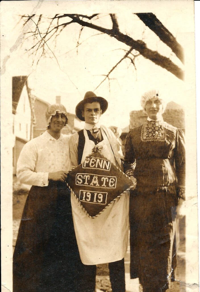 Photo showing Joel C. Swisher and two unidentified friends, holding a pillow embroidered with "Penn State 1919"