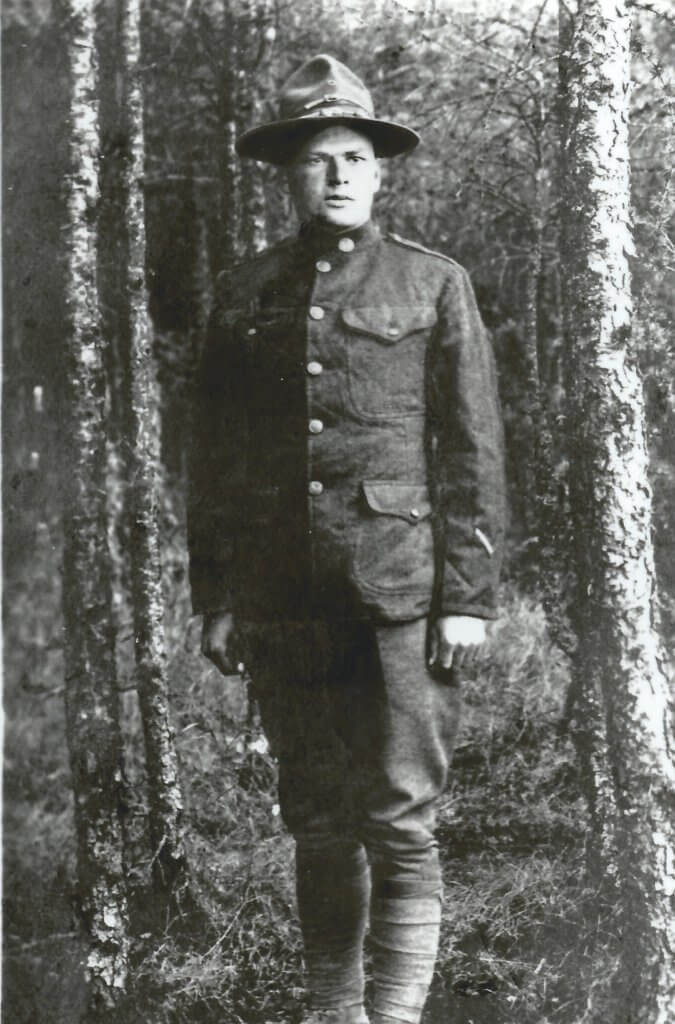 Photo of Joel C. Swisher, standing, in a US Army uniform